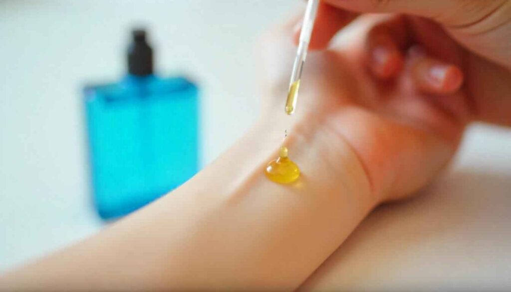 perfume oil without alcohol 1. A close-up of a hand applying perfume oil on the wrist, with a blurred bluish bottle in the background.